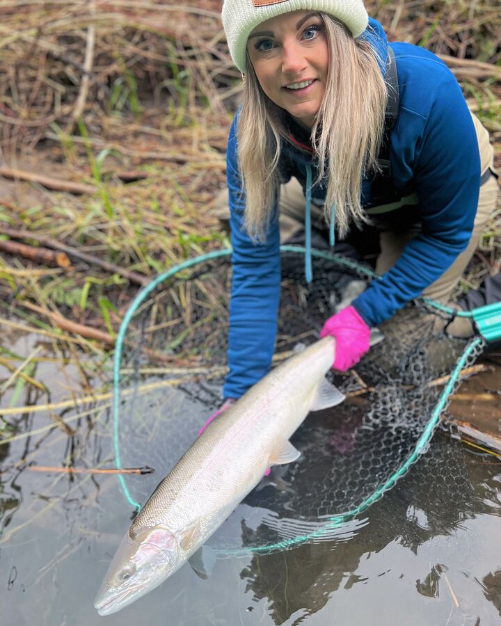 Two anglers with a steelhead in the net