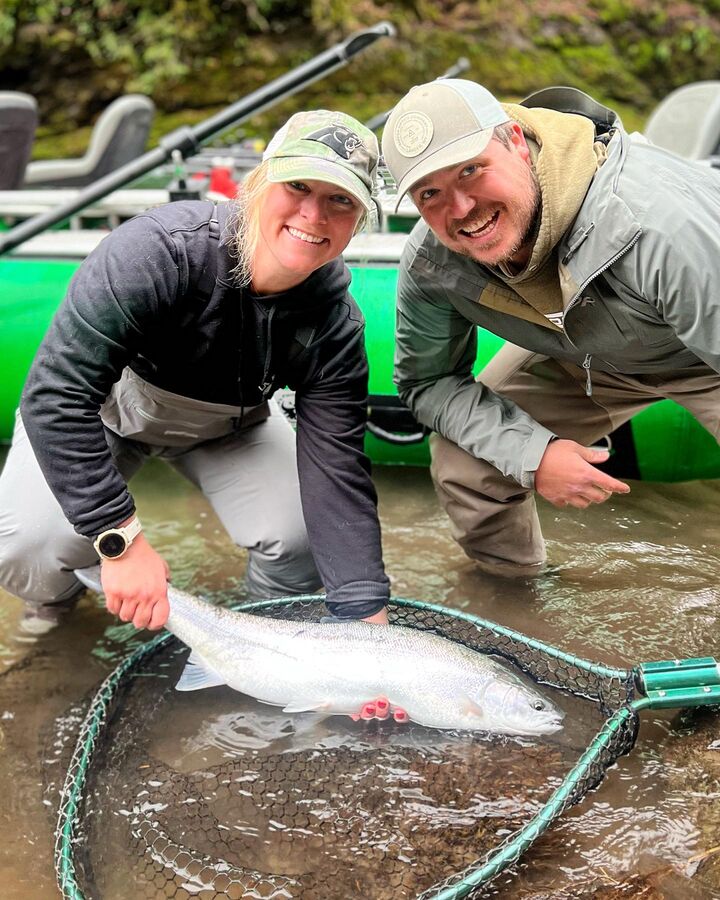 Angler with a steelhead in the landing net