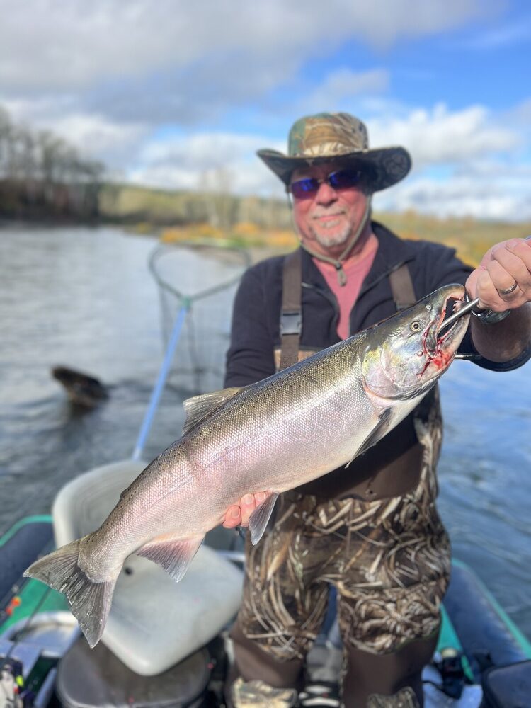 Angler on the jet sled holding a bright fall salmon
